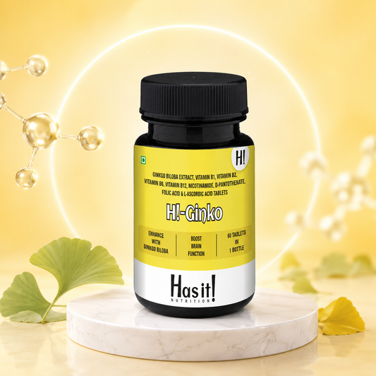 A bottle of Hasit Nutrition HI-Ginko tablets displayed on a white marble pedestal against a glowing yellow background with ginkgo leaves.
