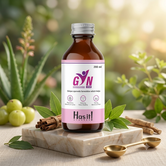 A 200 ml bottle of GYN Uterine Syrup Ayurvedic medicine with a pink and white label, styled on a marble block with amla fruits, cinnamon sticks, and brass spoons against a soft-focus green garden background.