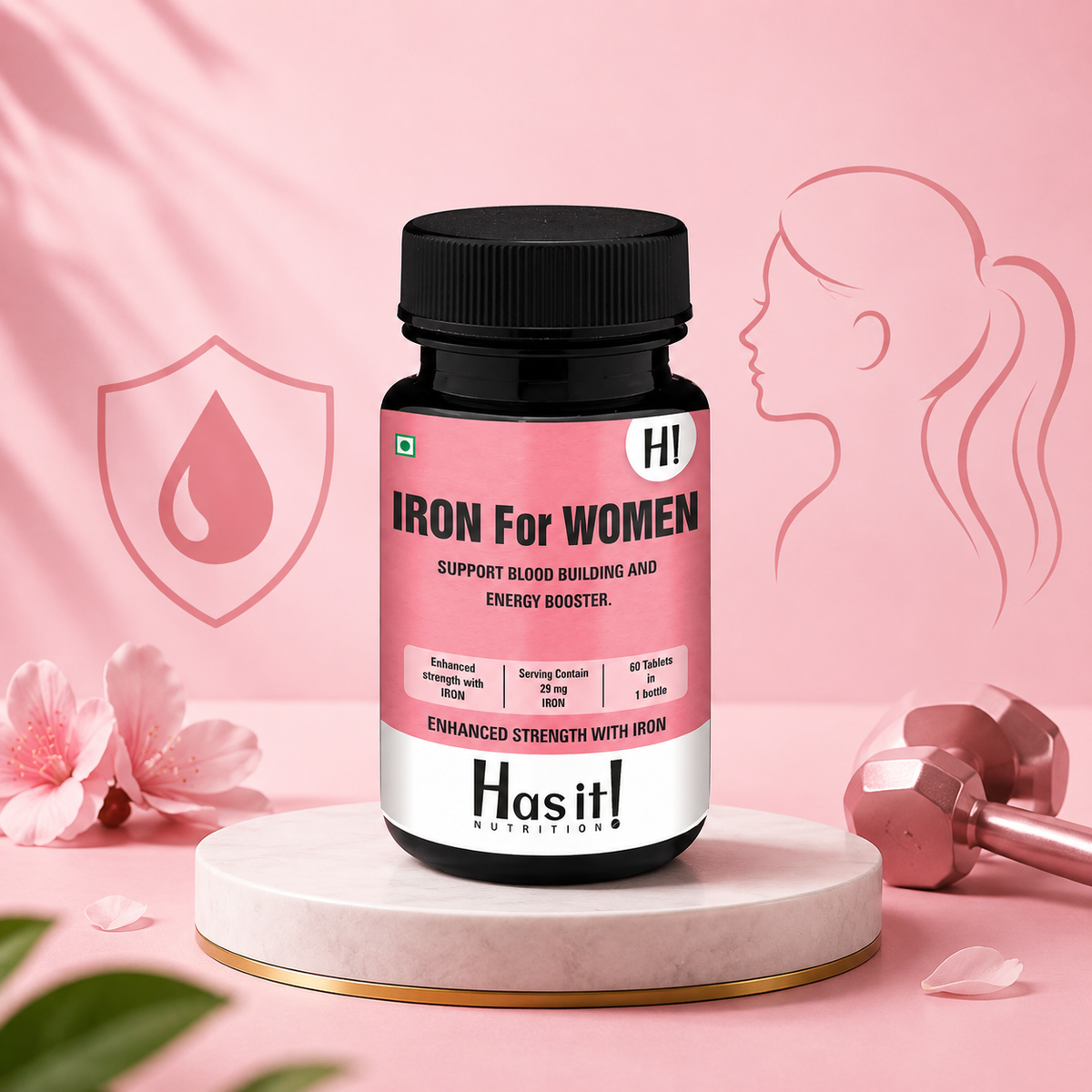 A bottle of Hasit! Nutrition 'Iron For Women' dietary supplement centered on a white marble pedestal. The background is a soft pink with decorative elements including a silhouette of a woman, a dumbbell, pink flowers, and a shield icon with a blood drop.